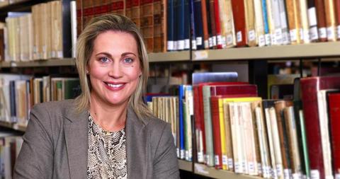 Smiling Professional Woman Standing in Library - Download Free Stock Images Pikwizard.com