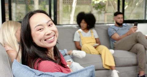Happy Friends Relaxing Together in Cozy Living Room