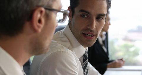 Businessmen Engaging in Discussion During Professional Meeting