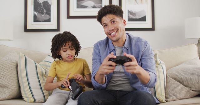 Happy biracial man and his son playing image games - Download Free Stock Photos Pikwizard.com