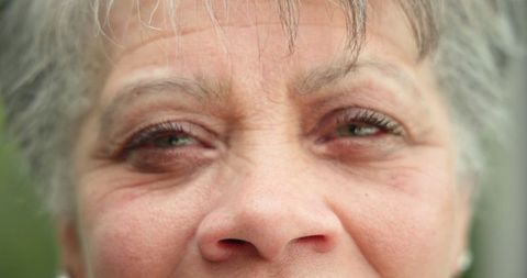 Senior woman embracing natural aging with grace in garden