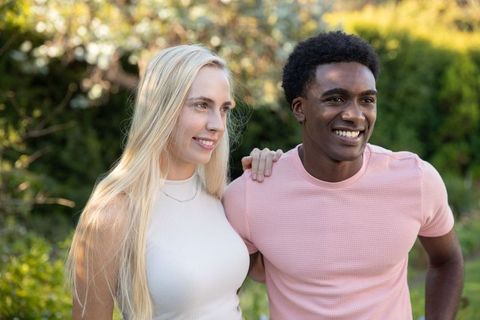 Diverse Couple Enjoying Lush Garden Together with Smiles