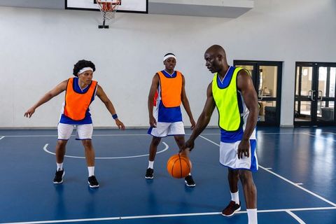 Basketball Players Engaged in Intense Court Practice Game
