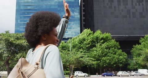 Smiling Businesswoman Waving in Urban Setting
