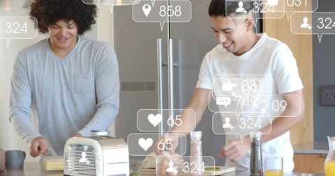 Two young men preparing breakfast sandwiches on kitchen island with floating social media icons