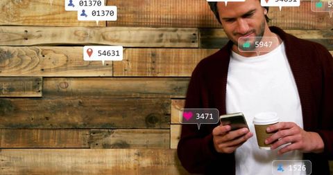 Man Checking Smartphone While Holding Coffee by Rustic Wood Wall with Social Media Notifications
