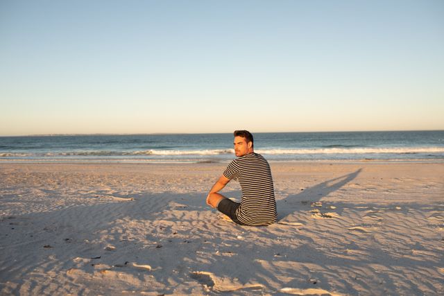 Man relaxing on the beach - Download Free Stock Photos Pikwizard.com