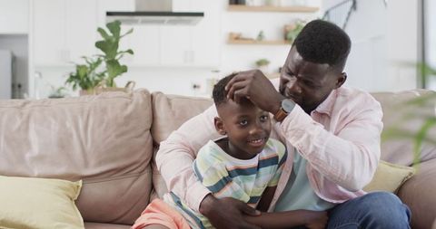 Father and Son Enjoy Quality Time on Living Room Sofa