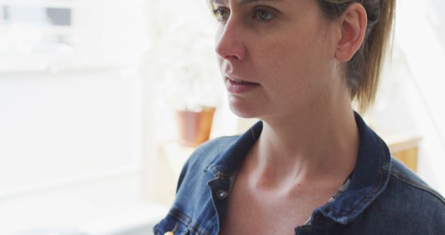 Thoughtful Woman in Denim Jacket Contemplating Indoors - Download Free Stock Images Pikwizard.com