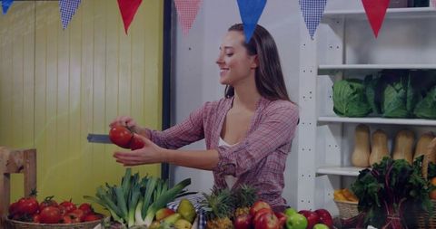 Market Vendor Slicing Tomato at Bustling Farmers Market Stall