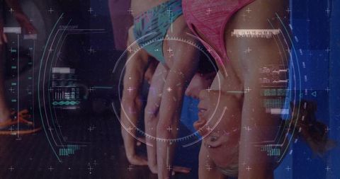 Female athlete performing inverted handstand in gym with futuristic hud interface
