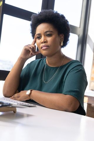 Thoughtful Businesswoman Analyzing at Office Desk