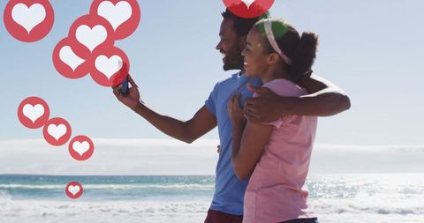 Happy Couple at Beach Sharing Moments on Smartphone