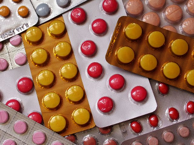 This image features a mix of blister packs containing various colored pills and tablets. It can be used in articles discussing healthcare, medication, pharmaceutical industries, health tips, or medical studies. Useful for blogs, medical publications, and pharmacies addressing medication usage, packaging design for drugs, or information on different types of medication.