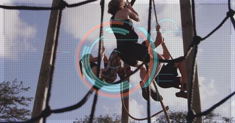 Man climbing rope with futuristic hud overlay on challenge course