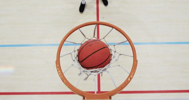 Basketball Going Through Net in Gymnasium - Download Free Stock Images Pikwizard.com