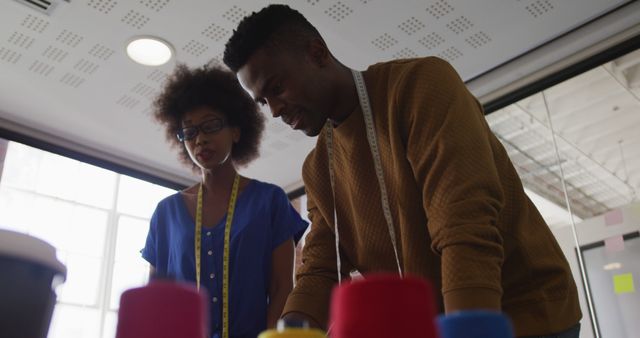 African american male and female fashion designers in discussion at work - Download Free Stock Photos Pikwizard.com