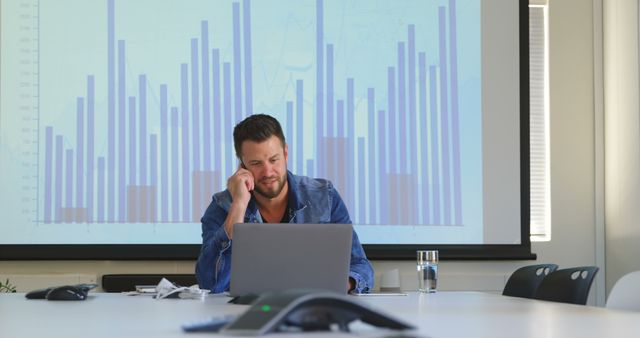 Businessman Analyzing Data on Laptop in Modern Office Conference Room - Download Free Stock Images Pikwizard.com