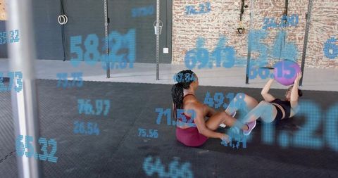Partner core workout passing medicine ball in industrial gym training studio