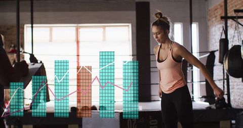 Female boxer in peach tank training with coach clipboard and performance analytics overlay