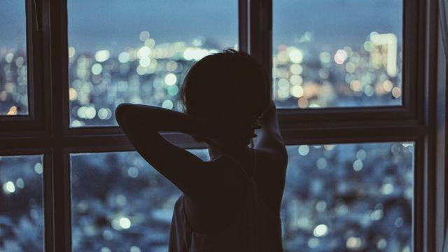 Child Looking Out City Window at Night, Contemplating Urban Life - Download Free Stock Photos Pikwizard.com