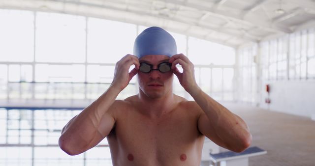 Swimmer Adjusting Goggles Near Indoor Pool - Download Free Stock Images Pikwizard.com