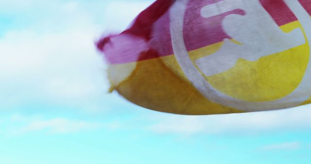 Colorful Flag Waving Against Blue Sky on Sunny Day - Download Free Stock Images Pikwizard.com