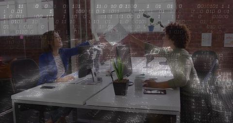 Fist Bumping Colleagues Celebrating Success in Modern Office