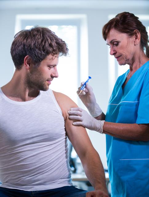 Healthcare professional administering vaccine to patient in clinical setting. Useful for illustrating medical procedures, healthcare services, vaccination campaigns, and patient care in hospitals or clinics.