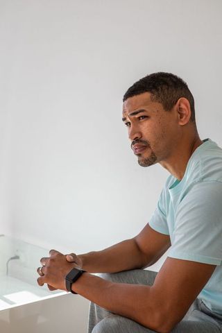 Pensive man contemplates in modern minimalist bathroom