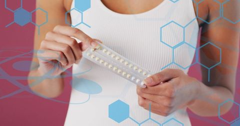 Woman Holding Birth Control Pills Showing Medical Technology