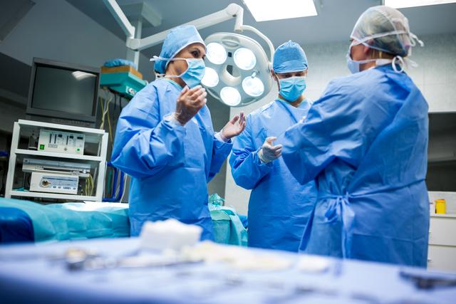 Surgical Team Communicating in Operating Room - Download Free Stock Images Pikwizard.com