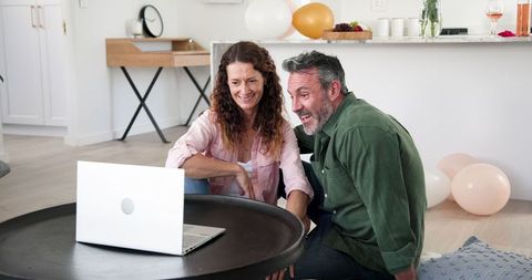 Happy Couple Video Calling Celebrating Engagement at Home
