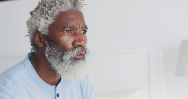 Thoughtful Senior Man with Gray Hair and Beard in Light Blue Shirt - Download Free Stock Images Pikwizard.com