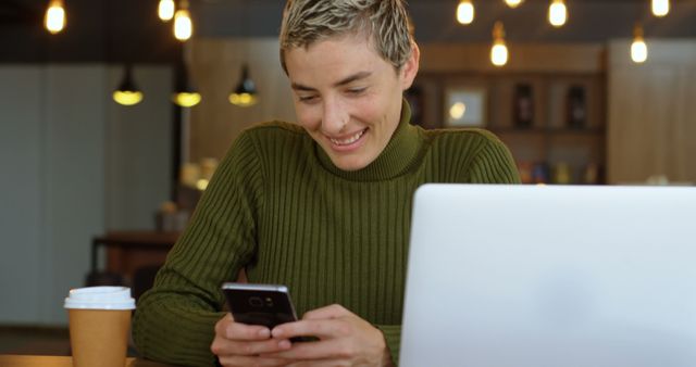 Young Professional Enjoying Smartphone while Working in Café - Download Free Stock Images Pikwizard.com