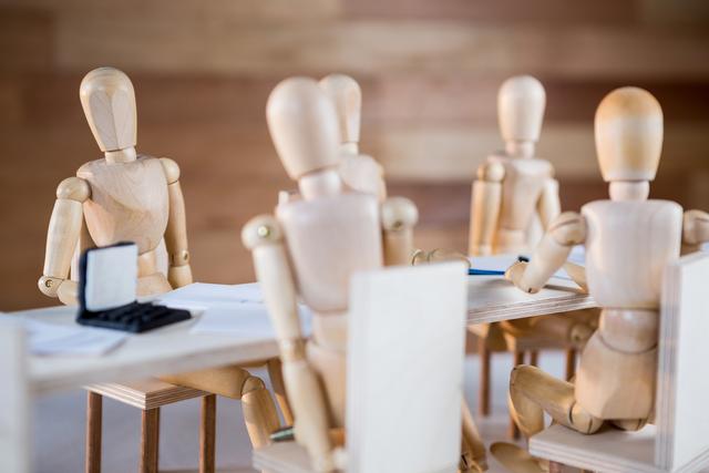 Conceptual image of figurine attending a business meeting in the conference room