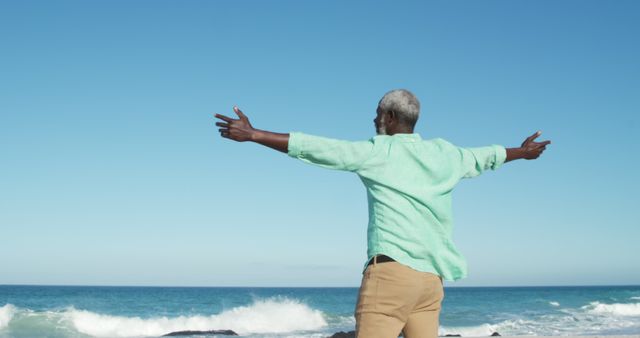 Senior Man Enjoying Freedom by the Ocean - Download Free Stock Images Pikwizard.com