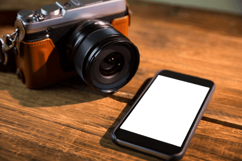 transparent modern camera and smartphone on wooden surface - Download Free Stock Videos Pikwizard.com