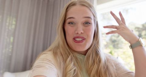 Cheerful woman animatedly conversing in cozy living setting