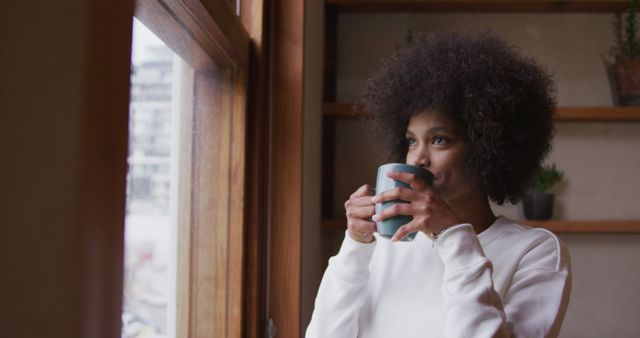 Woman Enjoying Coffee by Window on a Relaxing Morning - Download Free Stock Images Pikwizard.com