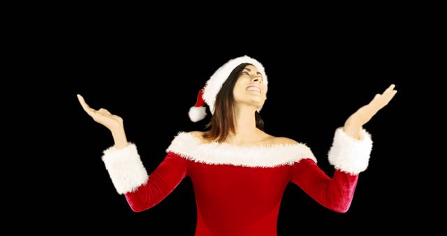 Happy Young Woman in Santa Claus Outfit against Black Background - Download Free Stock Images Pikwizard.com