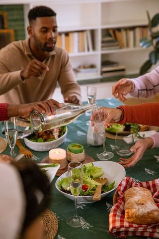Friends Enjoying Homecooked Meal in Cozy Dining Setting