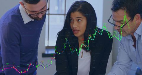 Business Team Analyzing Data with Financial Graph Overlay