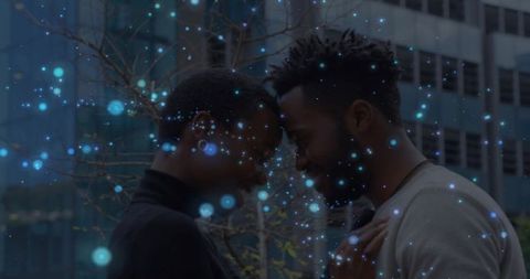 Couple touching foreheads in urban evening with blue bokeh lights, intimate reflections