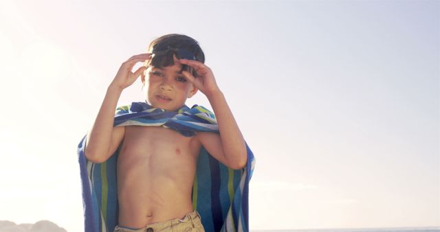 Young Boy with Towel Relaxing on the Beach, Wearing Goggles - Download Free Stock Images Pikwizard.com