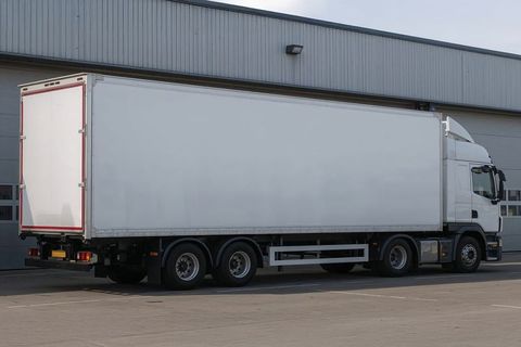 White Semi-Trailer Truck in Industrial Warehouse Yard