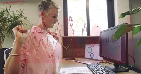 Woman stretching at desk with live charts reacting on monitors in modern office