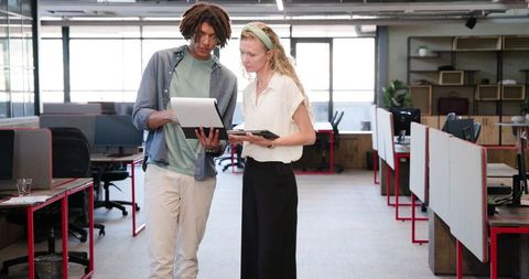 Colleagues Reviewing Documents in Collaborative Office Environment