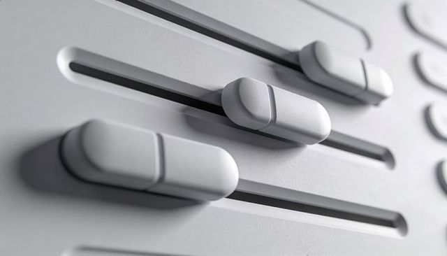 Minimalist audio mixer sliders sliding on recessed tracks with soft shadows