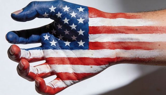 Forearm bearing american flag body paint showing stars and stripes closeup